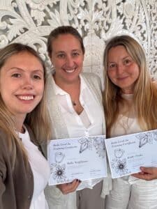 Holly Neighbours holding Reiki Master certificate with open heart